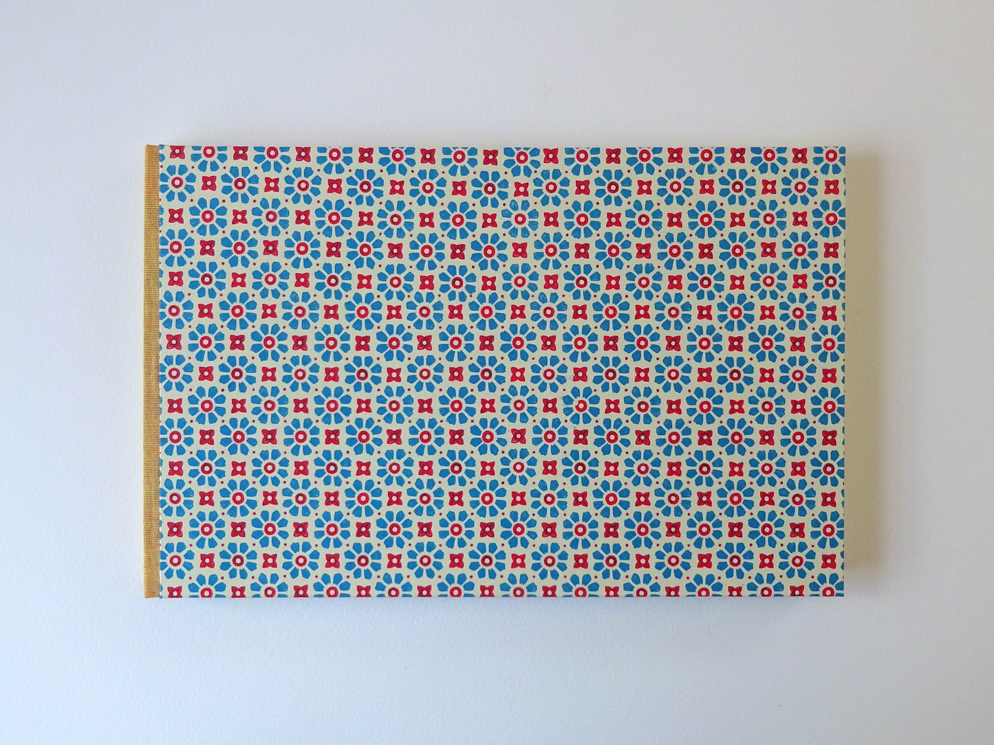 large hand bound watercolour sketchbook with blue Italian pattern paper and yellow spine