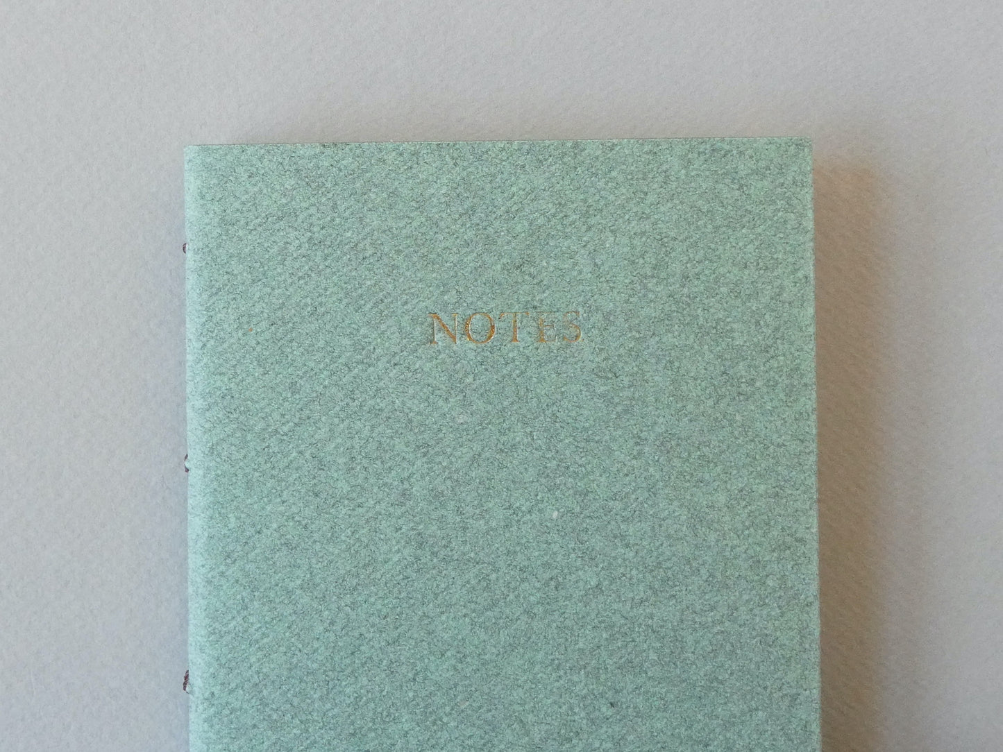 Celandine Books green notebook with gold lettering