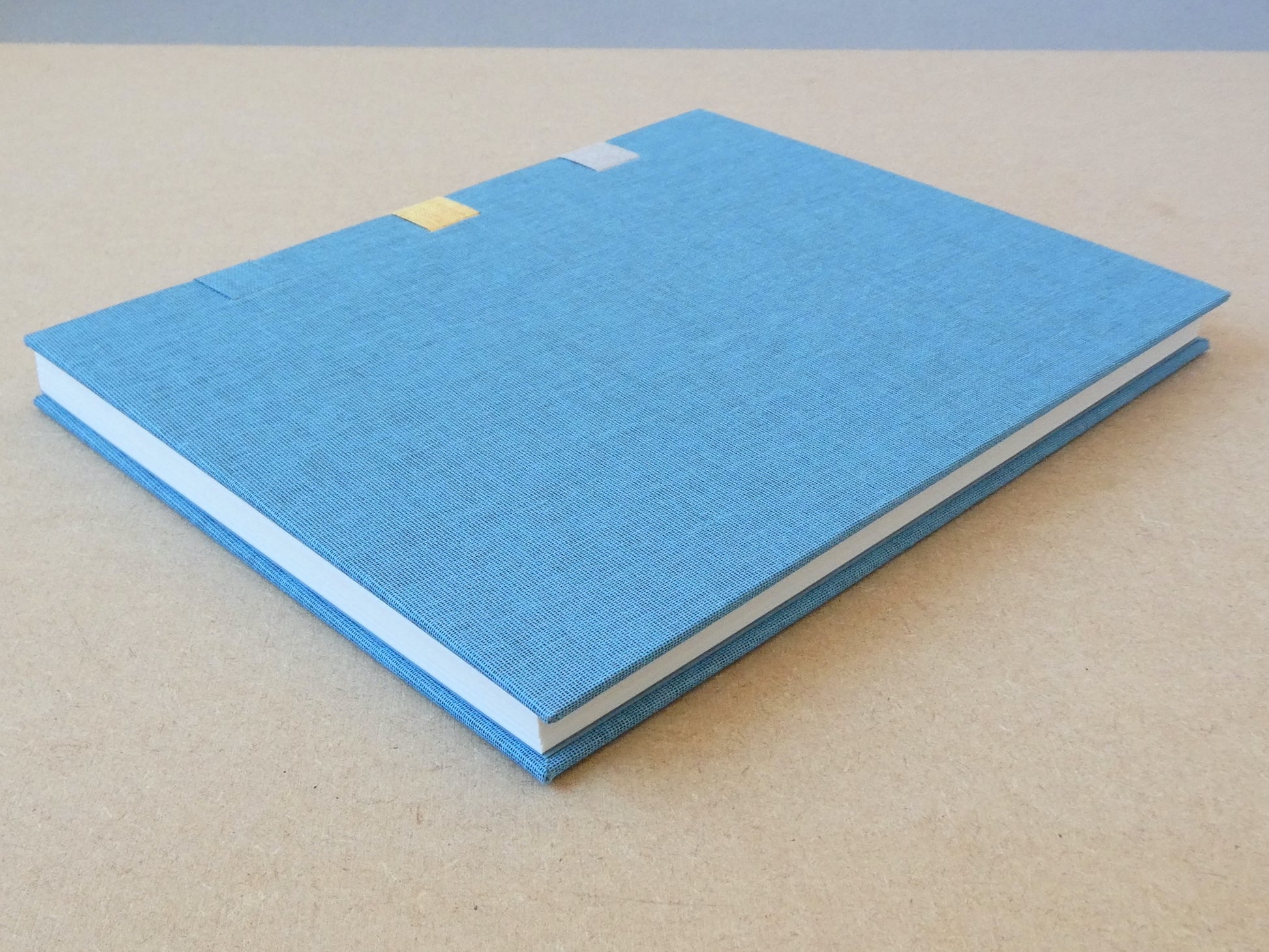 Blue notebook on a beige surface