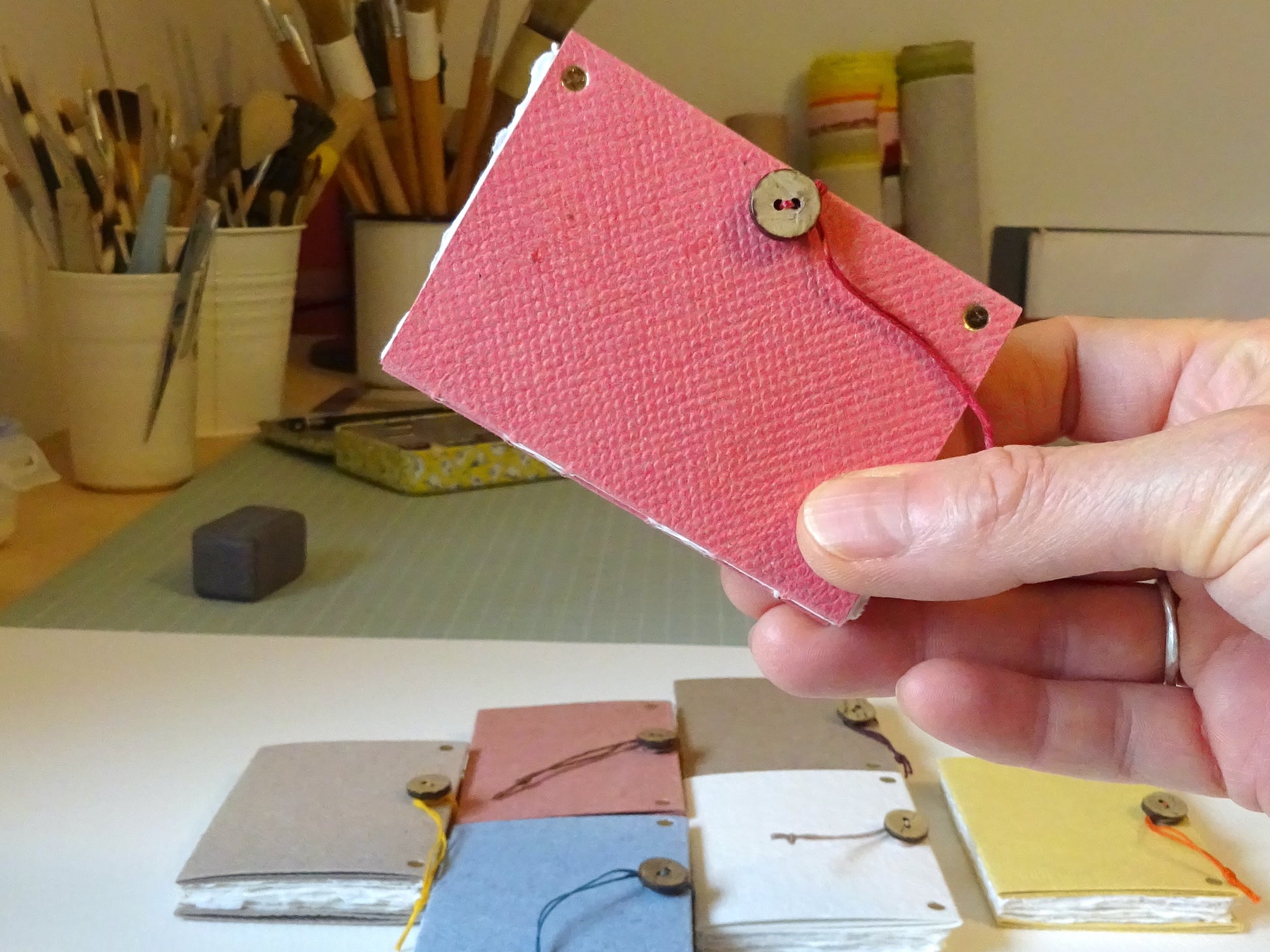 pink handmade paper mini book held in hand