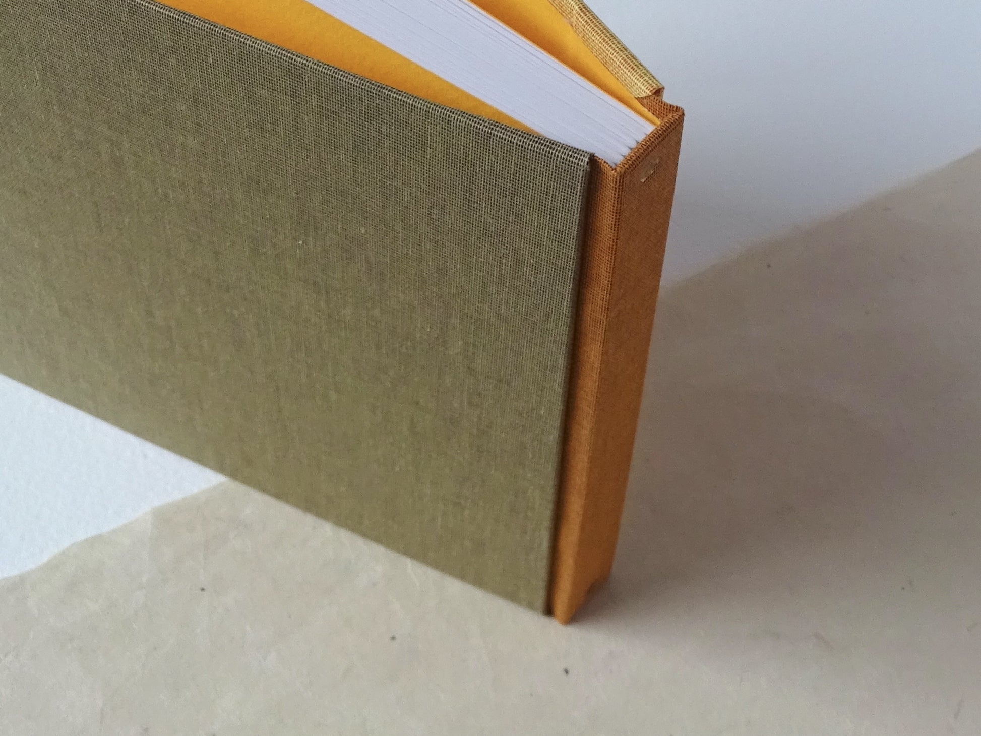 three colours square hand bound sketchbook mustard standing