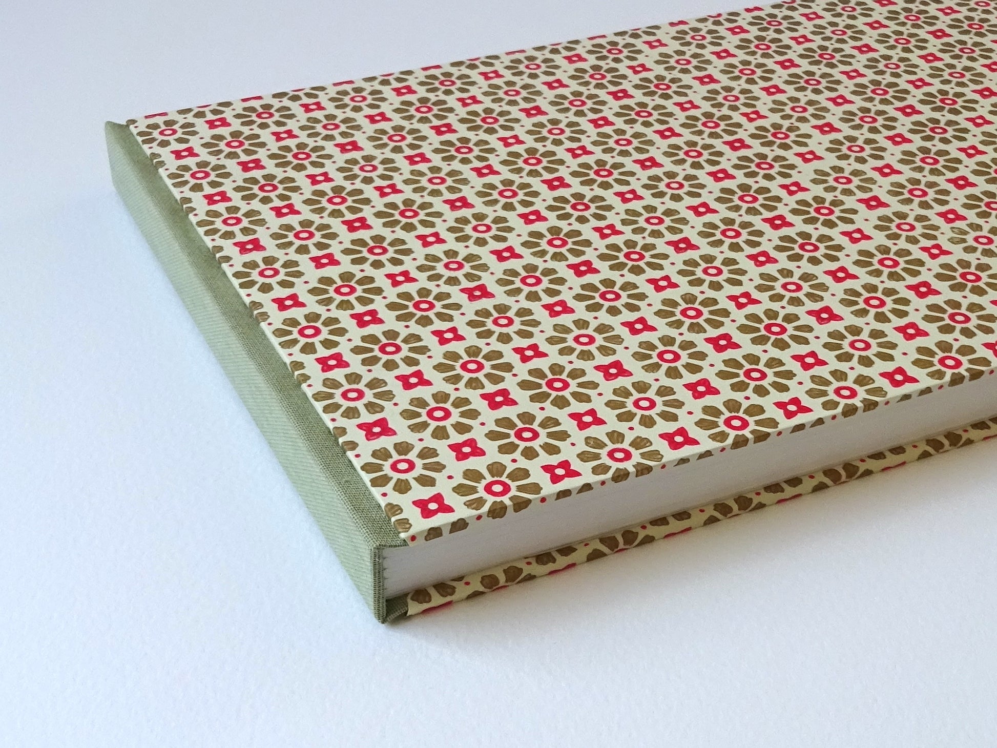 large hand bound watercolour sketchbook with green and red Italian pattern paper spine detail
