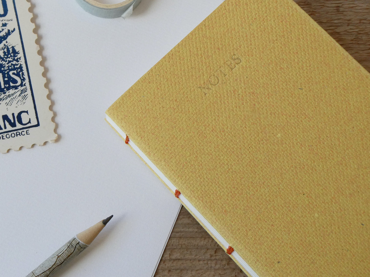 Celandine Books yellow notebook with pencil