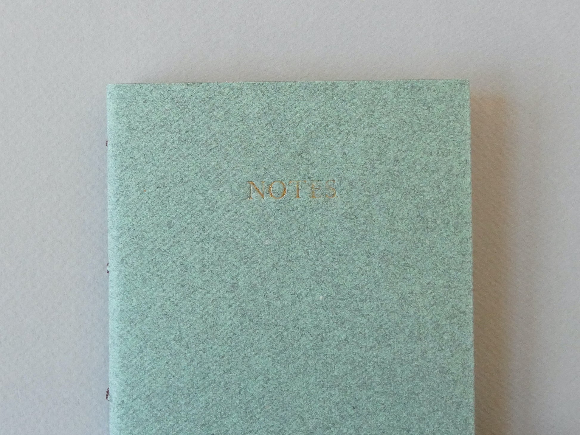 Celandine Books green notebook with gold lettering