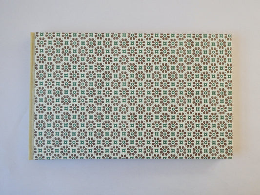 Handmade sketchbook with Italian patterned paper cover on a white surface