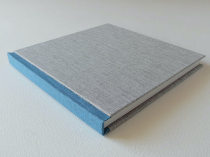 Grey and blue hand bound sketchbook on a white background