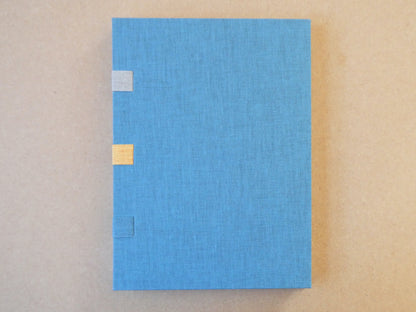 Blue textured box with gold accents on a beige background