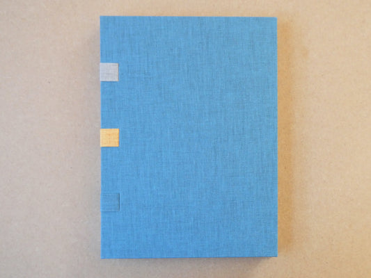 Blue textured box with gold accents on a beige background