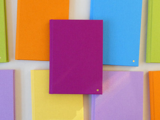Colourful notebooks arranged in a pattern on a white background