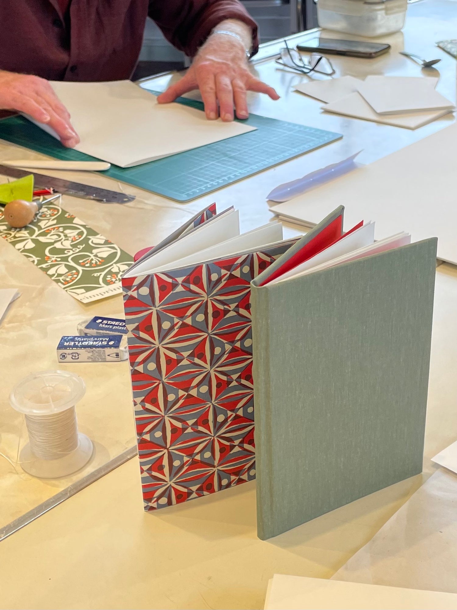 Two handmade books at a bookbinding workshop