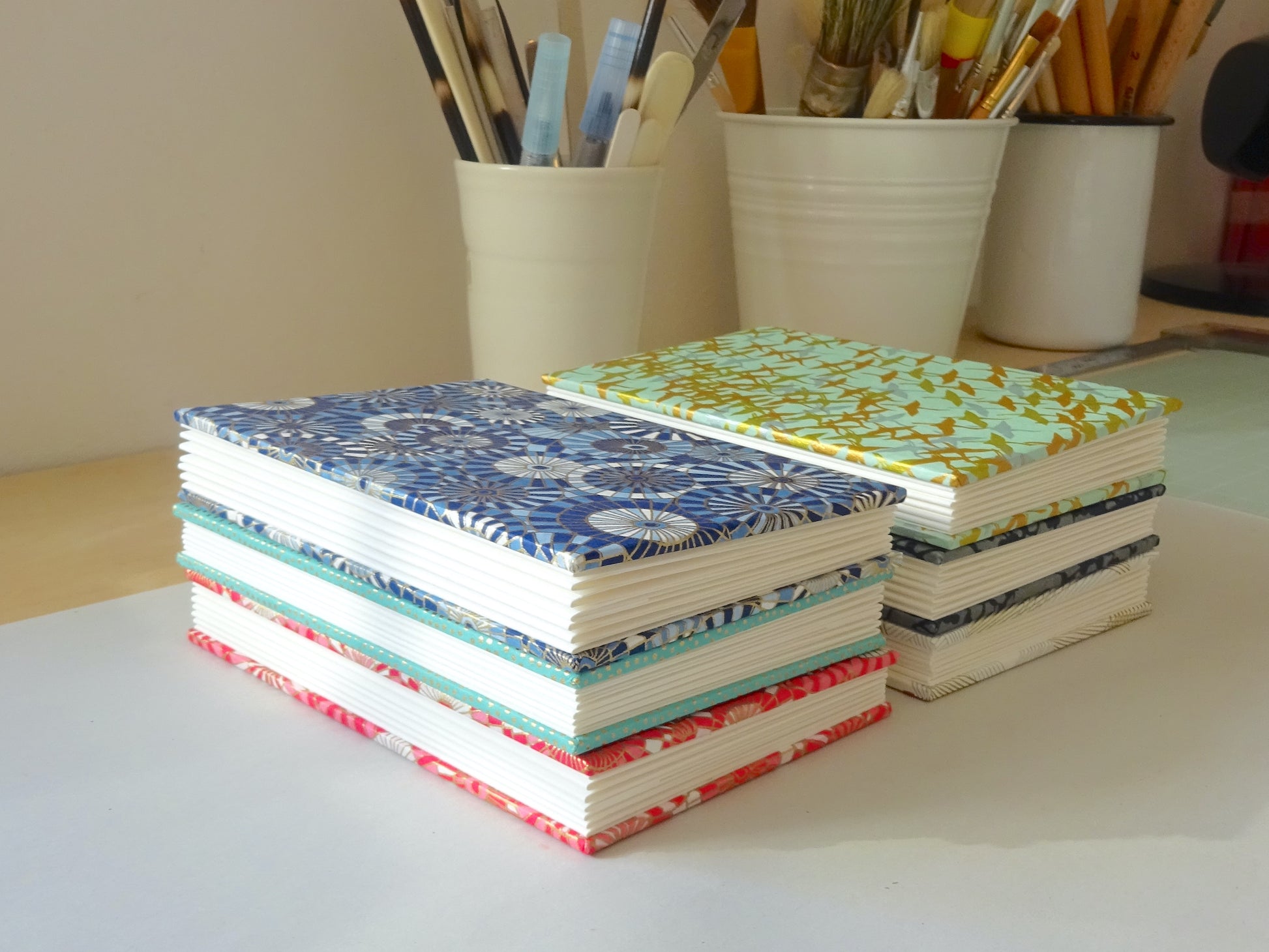 Stack of Chiyogami  Concertina Watercolour Sketchbooks on bench